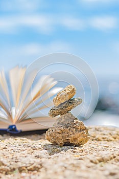 Small stones on the background of an open book