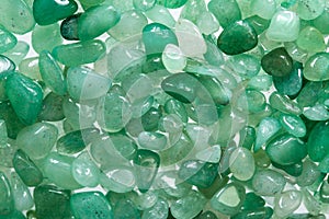 Small stones of green aventurine. Ornamental stone in the form of fine-grained pebbles