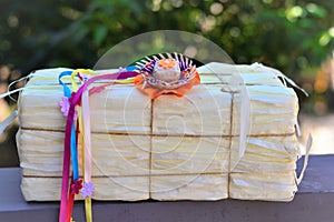 Small straw hat with colorful ribbons on the fake hay bale