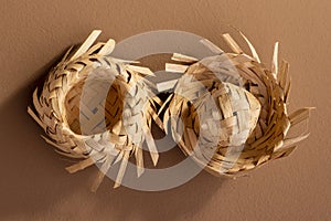 Small straw hats used for festa junina ornaments on brown background