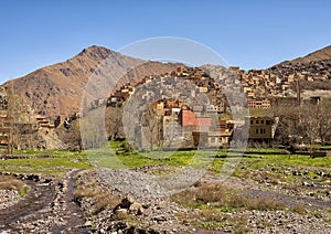 Small stream and a Berber village in the High Atlas Mountains of Morocco.