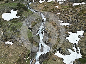 Small stream flowing by a rocky hillside near the Switzerland Mountains