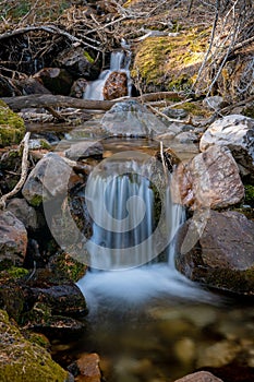 Small stream with a tiny waterfall over the rocks