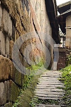 Small street extend, with stone wall and road