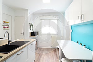 small student kitchen with blue wall