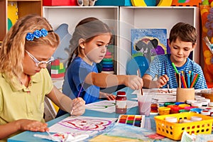 Small students children painting in art school class.