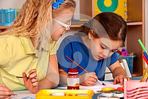 Small students children painting in art school class.