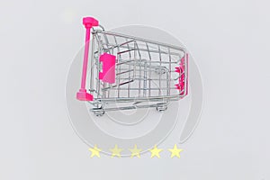 Small supermarket grocery push cart for shopping toy with wheels and 5 stars rating isolated on white background. Retail consumer