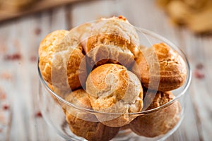 Small sweet dessert profiteroles in a glass photo