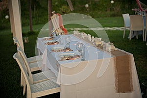 A small table await the bride and groom at this garden reception