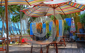 Small table and colorful parasol in a cafe near the ocean  at Cairns Cape Tribulation Australia