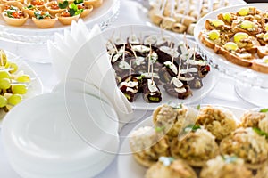 A small table with a delicious buffet of canapes, caviar, sandwiches