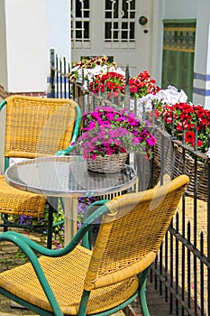 Small table and two chairs on a fenced terrace