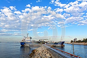 Small tanker during loading at a pier.