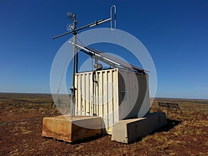 Small telecommunications hut with microwave dishes