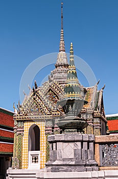 Small temple with spires against a dark blue sky at Grand Palace, Thailand