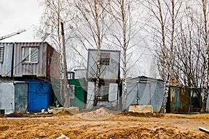 Small temporary houses of builders from containers at an industrial construction site. Block-modular construction city