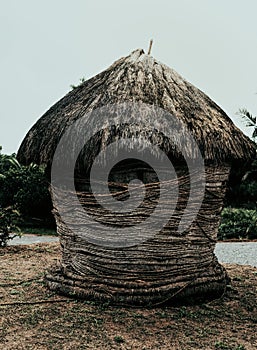 Small thatched roof hut built using natural materials like paddy straw or other natural things