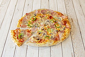 Small Thin Crust Pizza with Mushrooms, Ham, Sliced Green Peppers and Spicy Pepperoni with Mozzarella Cheese