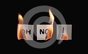 Small three papers with "OH NO!" burning on a black background