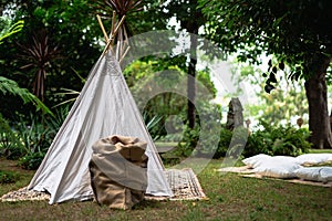 Small tipi indian tent with pillows in the woods