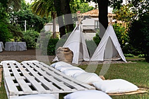 Small tipi indian tent with pillows in the woods