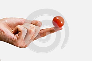 Small tomato on a female fingers