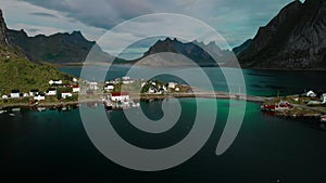 Small town against fjords with rocky shores aerial view