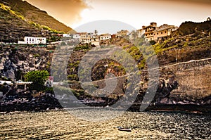 Small town on a cliff with sunset. Spanish village on a hill. Road trip on Tenerife, Canary Islands