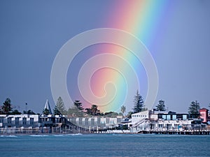 small town on the coast line sea with a real rainbow