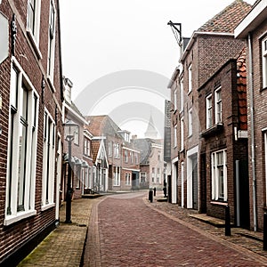 Small town Den Hoorn on the Texel island. Empty street in foggy morning. The Netherlands, Europe