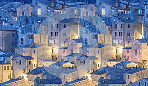 Small town in the evening illumination, vintage houses pattern panoramic background