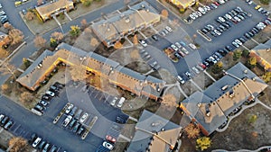 Small town neighborhood, trees with homes in aerial drone view on autumn late time