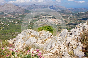 Small town of Parcent in distant flat plains between mountains from Coll de Rates range photo