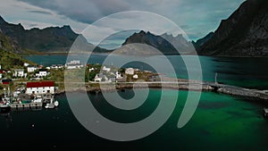 Small town on sea peninsula beach against fjords and hills