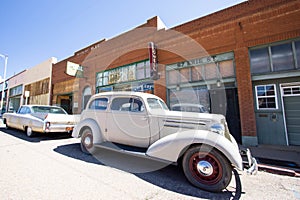 Small-town street with old cars