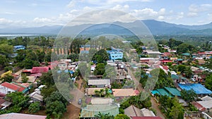 a small town is surrounded by trees and mountains in the background