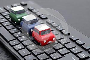 Small toy car on computer keyboard