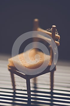 A small toy chair stands in a dark room