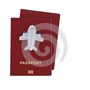 Small toy plane on top of two red passports