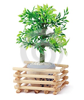 Small toy tree in pot, wooden sticks