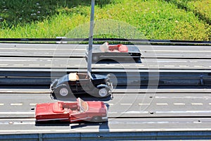 Small toys cars on a road near grass