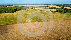 Small tractor in a big field