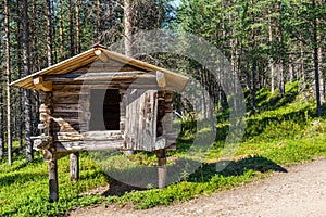 Small traditional log house on wooden posts in which the Sami i