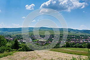 Small Transylvanian village at summertime , blue sky with white clouds