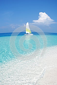 Small tropical sandbank with a boat