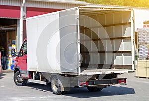 small truck with red cab stands with open empty body ready for loading cargo. ?lipping path is included photo