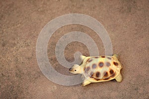 Small turtle statue on sandstone floor