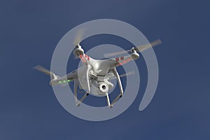 Small unmanned helicopter with a camera floating in sky