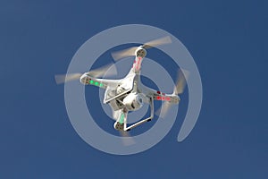 Small unmanned helicopter with a camera floating in the sky